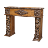 Antique fireplace from around 1880 in solid hand-carved elm with openwork columns.