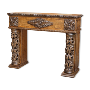 Antique fireplace from around 1880 in solid hand-carved elm with openwork columns.