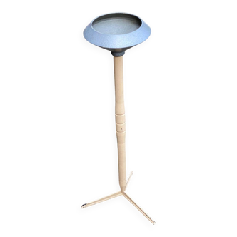 Vintage ashtray on a beige and grey metal stand.