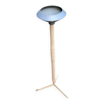 Vintage ashtray on a beige and grey metal stand.
