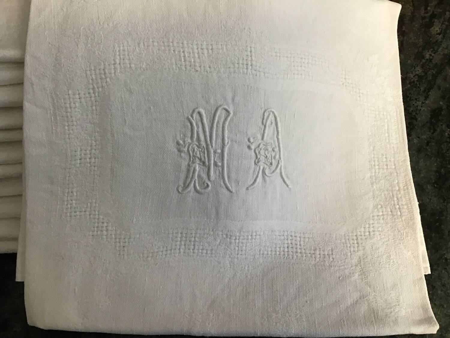 Damask napkins embroidered with an MA monogram