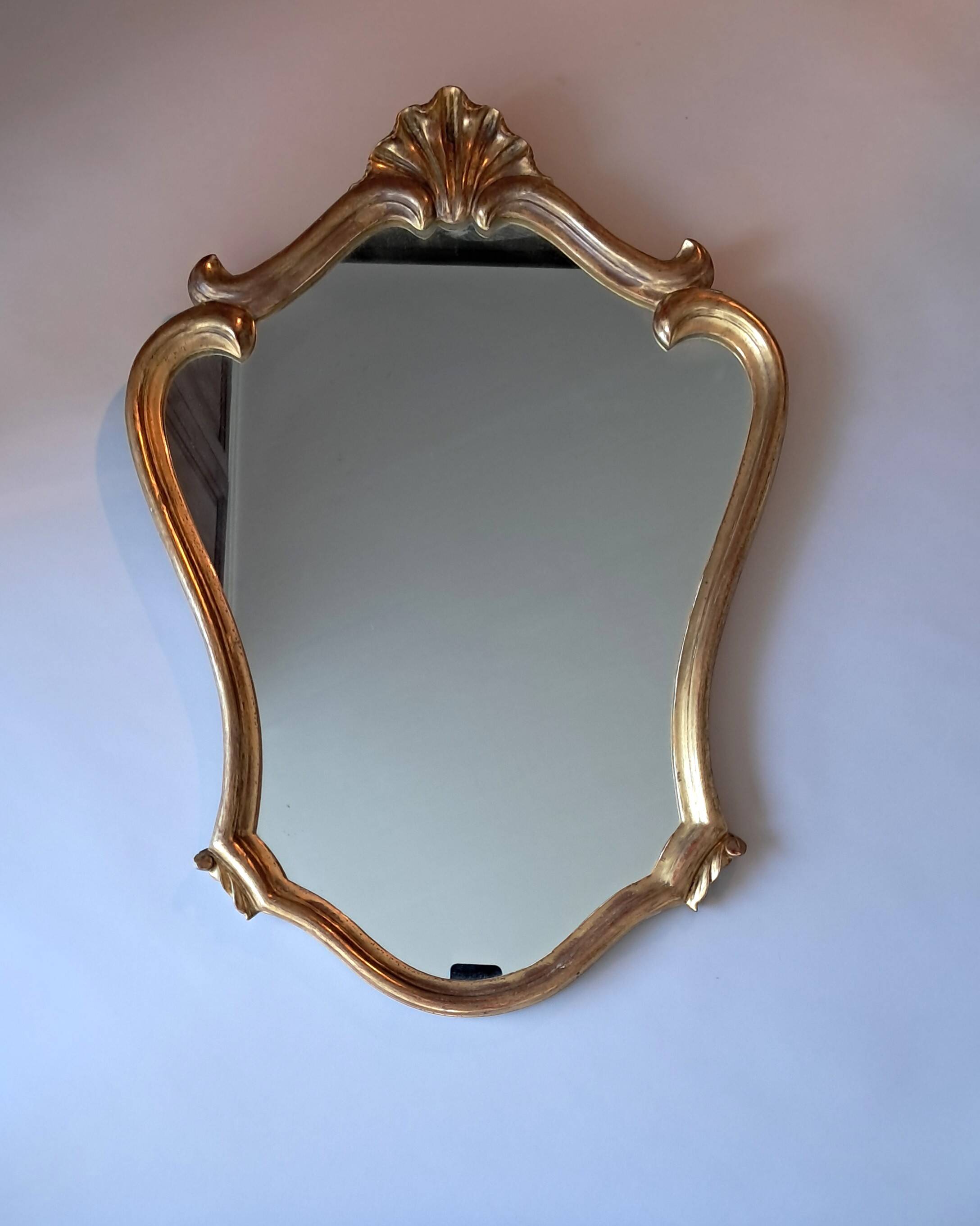 1950s rococo mirror in gilded stucco.