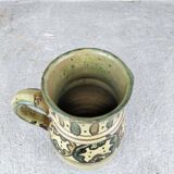 Glazed earthenware pitcher signed Riou.