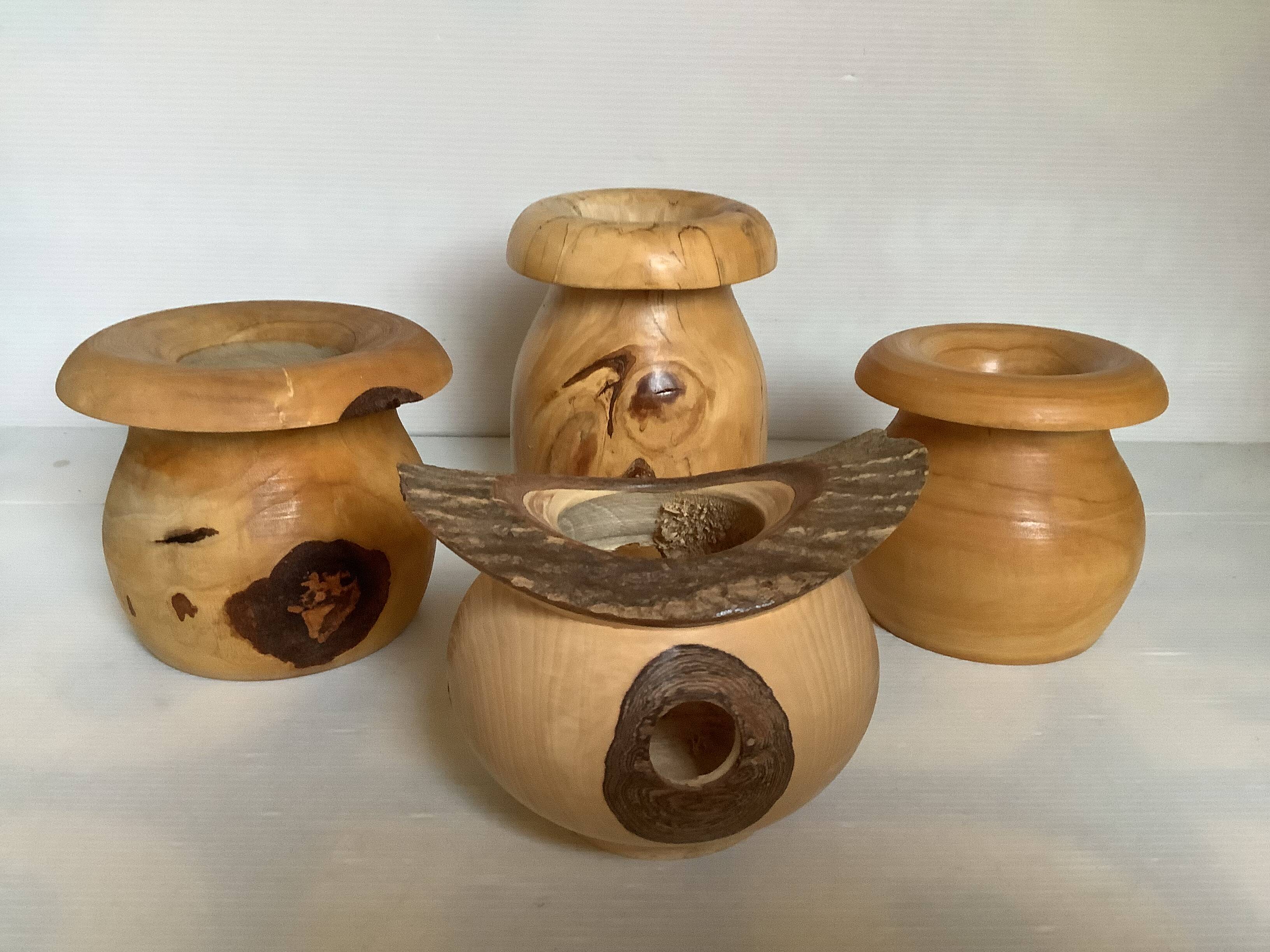 Four solid turned wooden vases