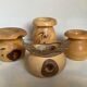 Four solid turned wooden vases