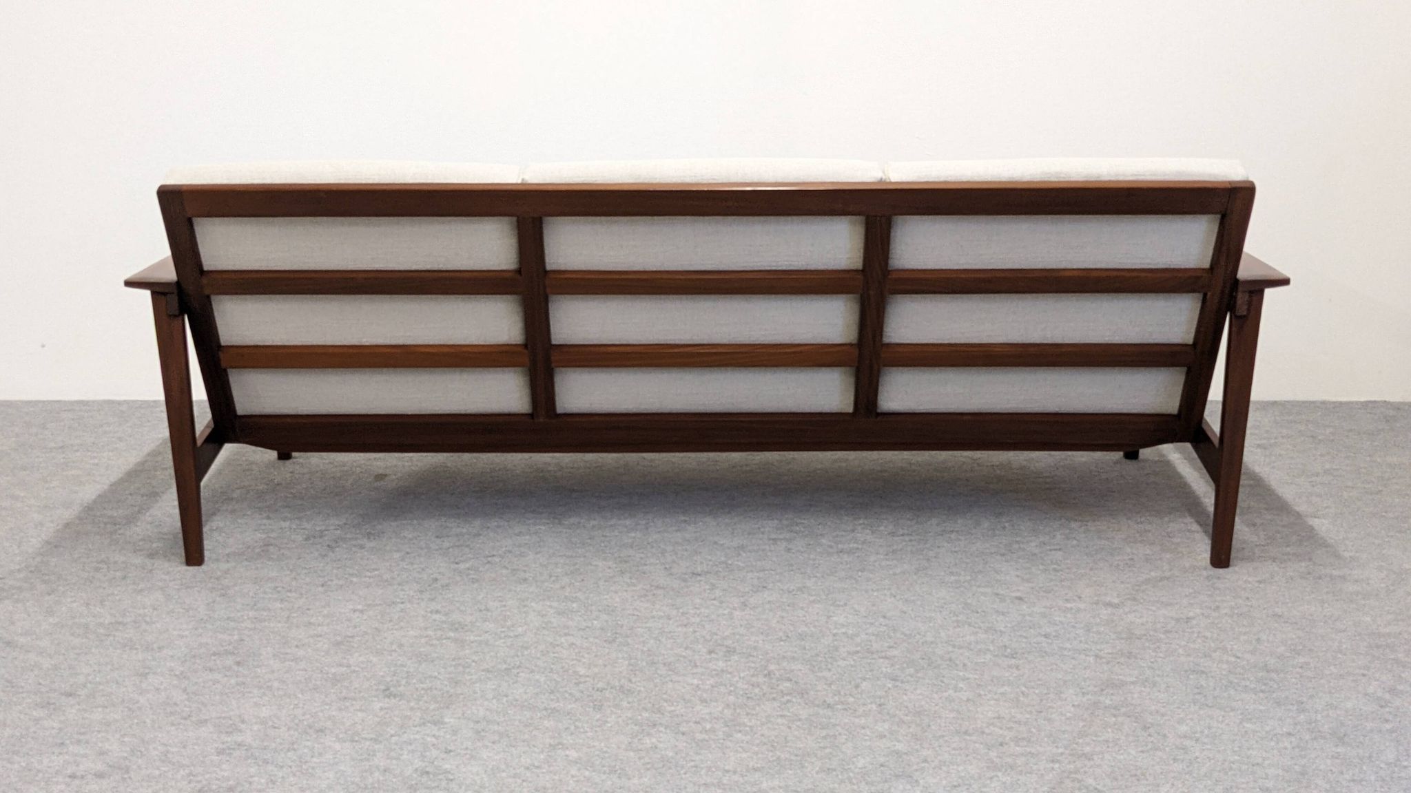 Three-seater modernist teak sofa, France circa 1950.