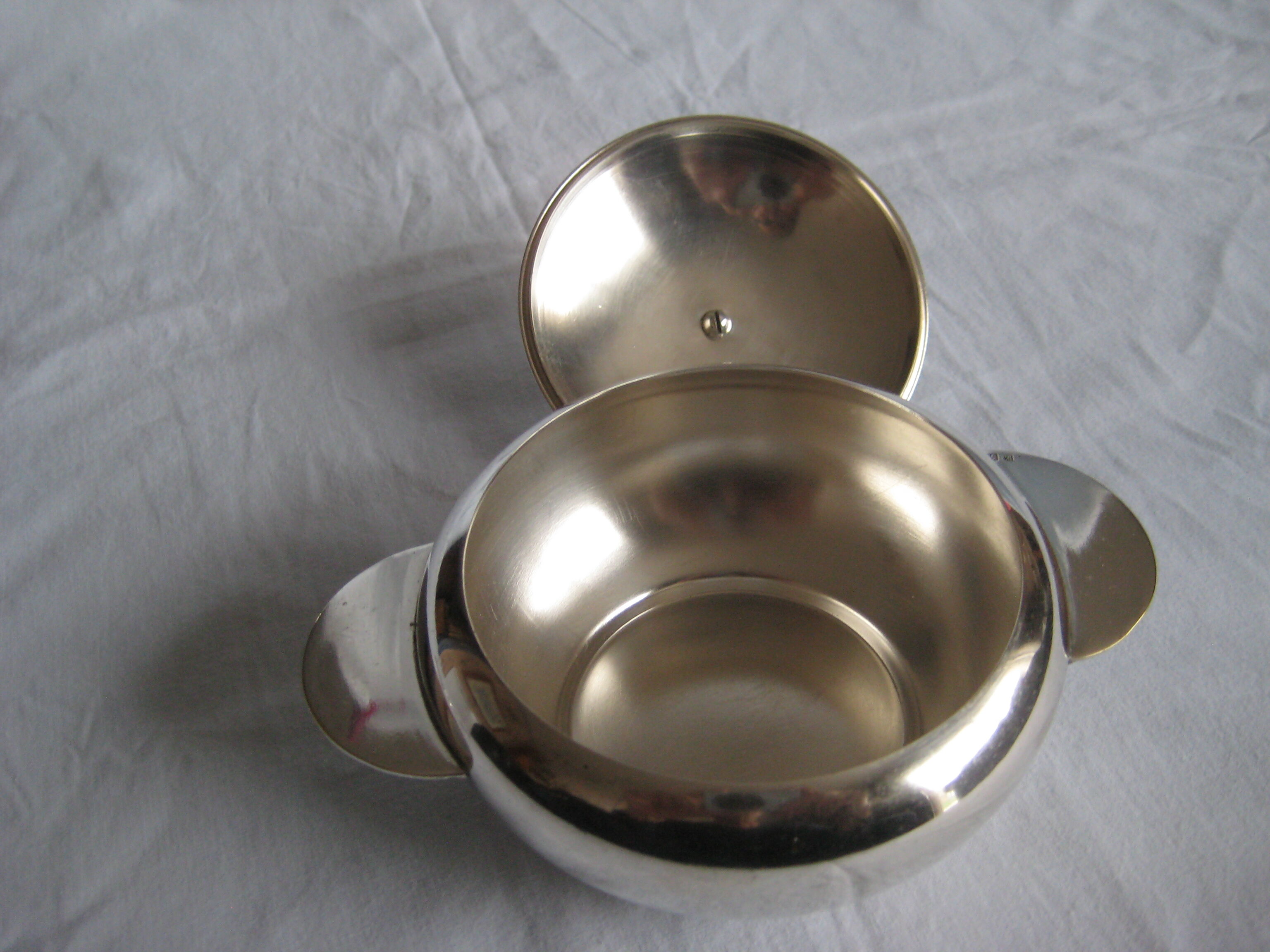 silver metal sugar and silver sugar spoon.