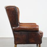 Cognac-colored vintage sheep leather wingback chair with character
