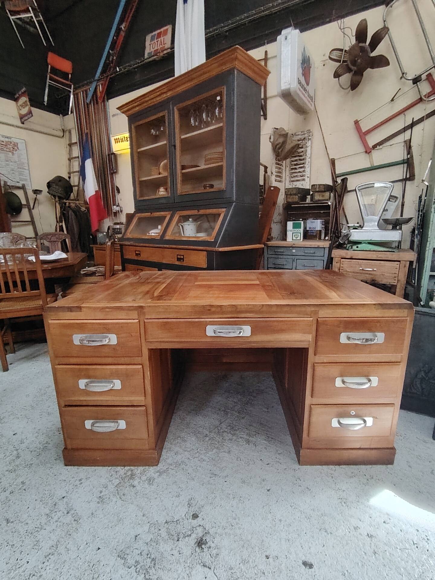 Large modernist minister's desk in solid lemon wood with 7 drawers.