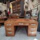 Large modernist minister's desk in solid lemon wood with 7 drawers.