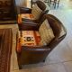 Brown cowhide armchair with a reversible seat cushion in KELIM.