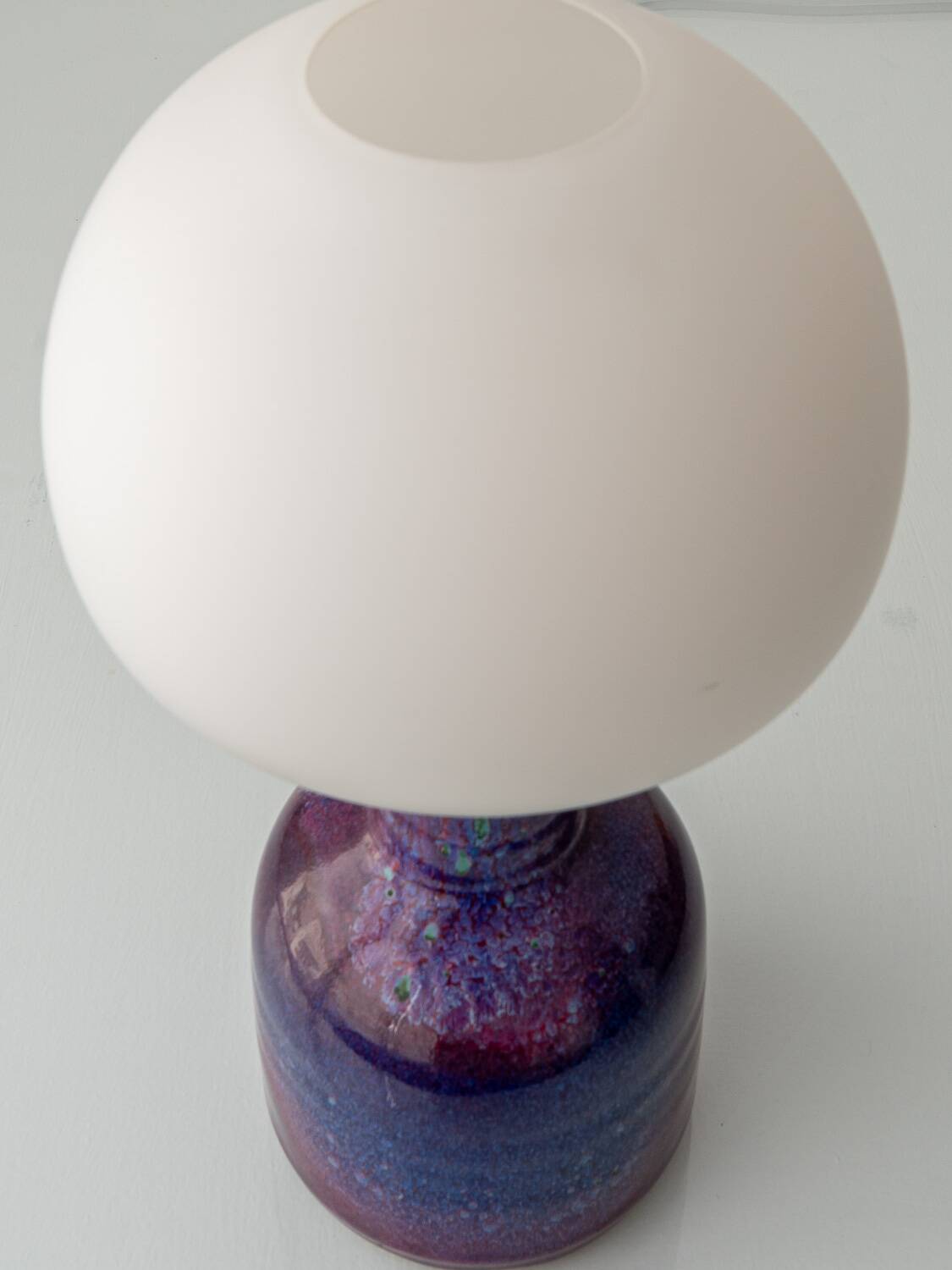 Mid-century modern table lamp by Jaap Ravelli, ceramic base and glass shade.