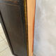 Antique wooden wall panel with carving and cane in an Asian style.