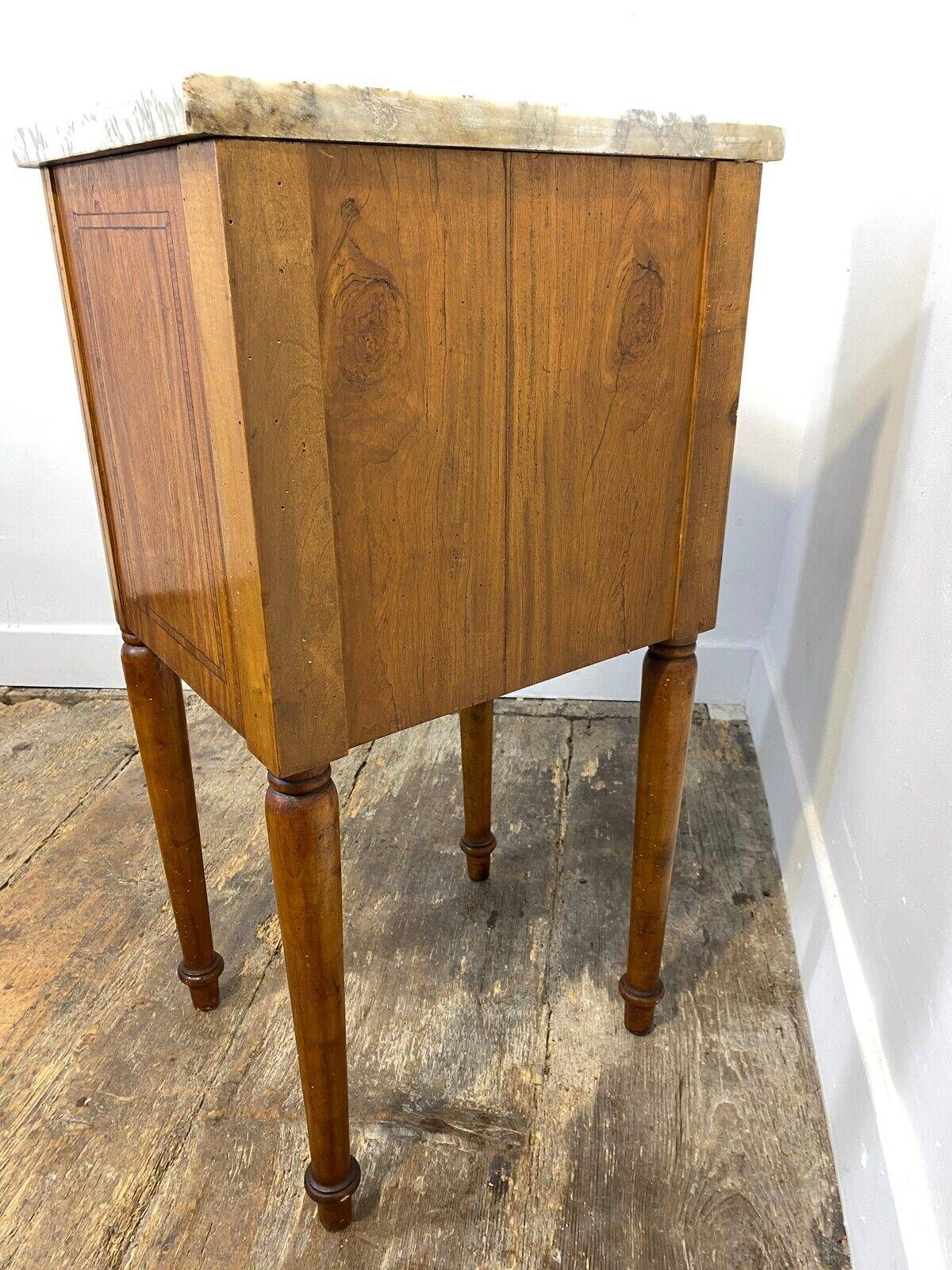 Louis XVI style bedside table, with a marble top and marquetry.