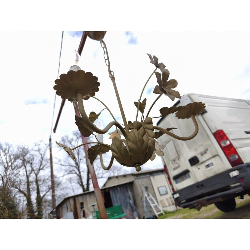 Vintage gold metal chandelier with floral decoration.