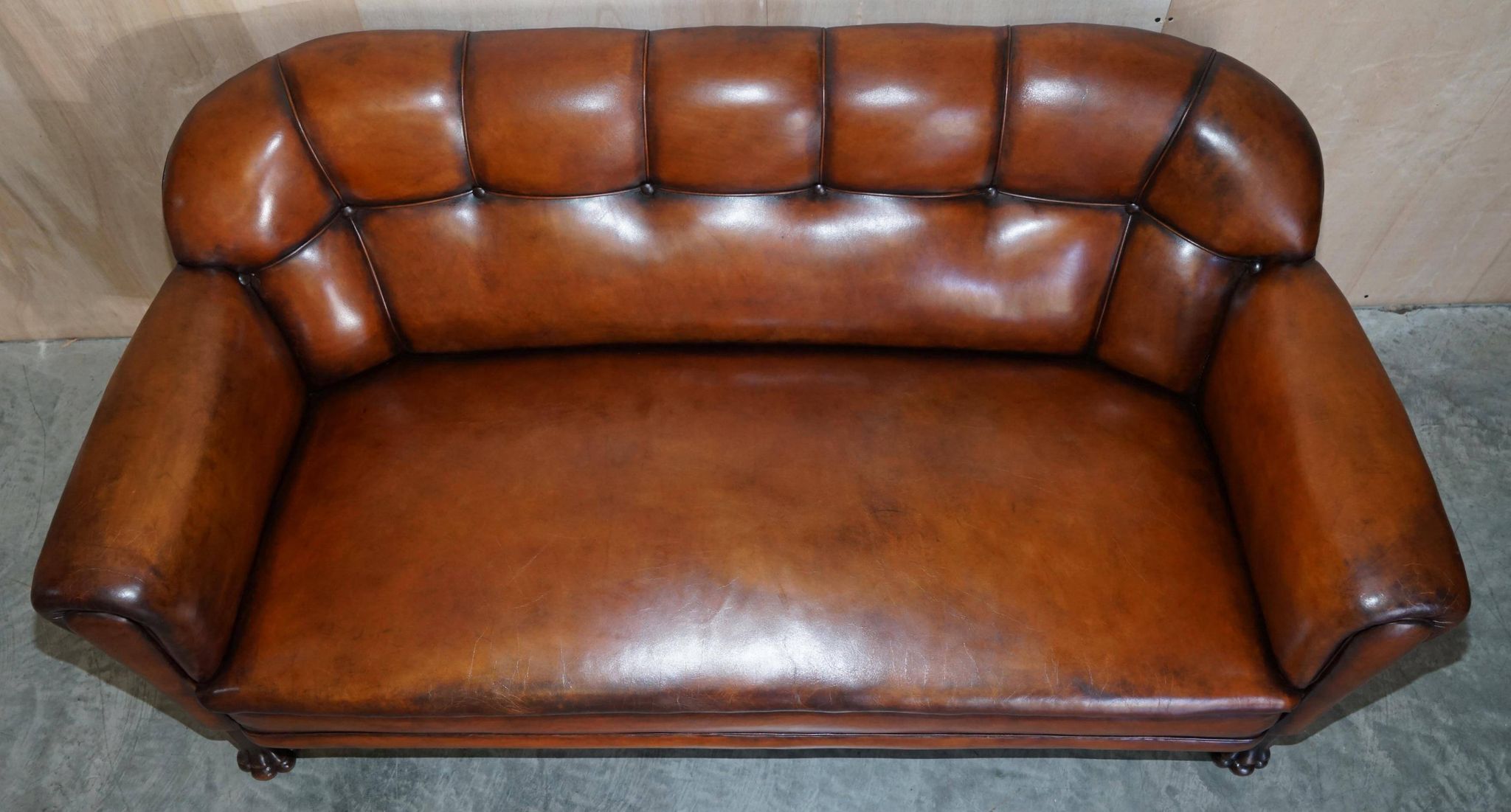 Victorian Chesterfield leather canapé with oak lion claw feet.