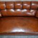 Victorian Chesterfield leather canapé with oak lion claw feet.