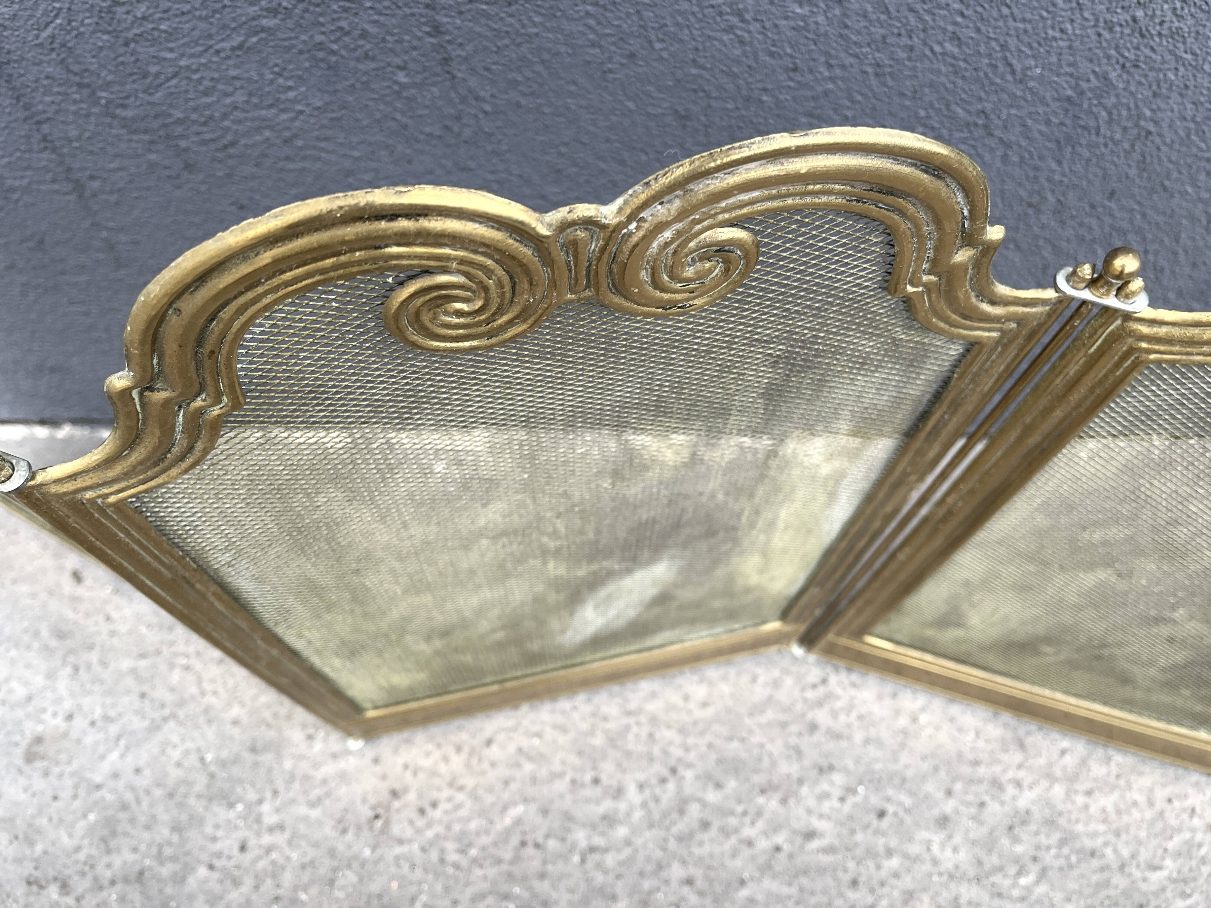Antique brass fireplace screen from 1920, vintage spark guard.