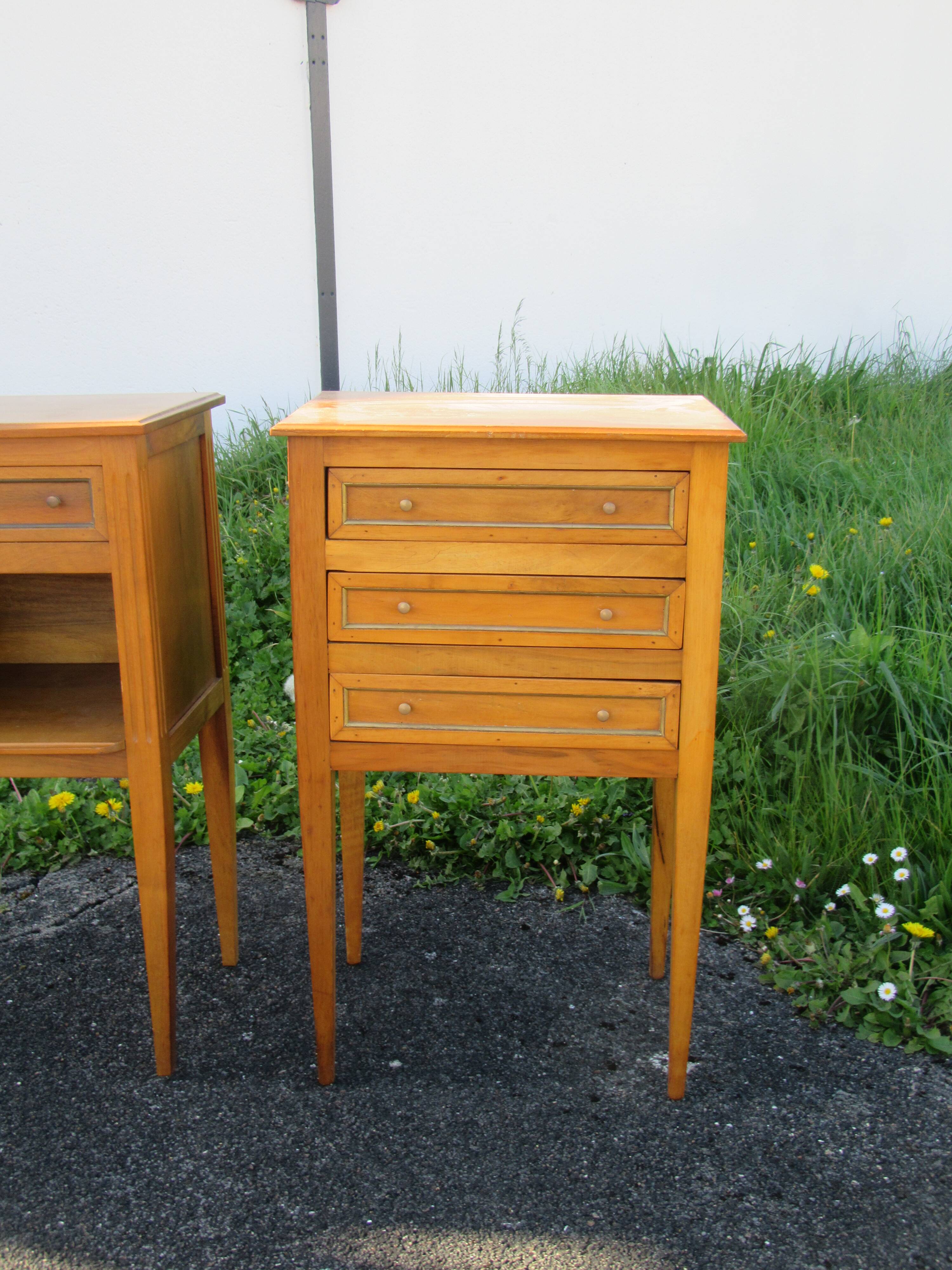 Pair of walnut bedside tables in Louis XVI style with brass inlay.