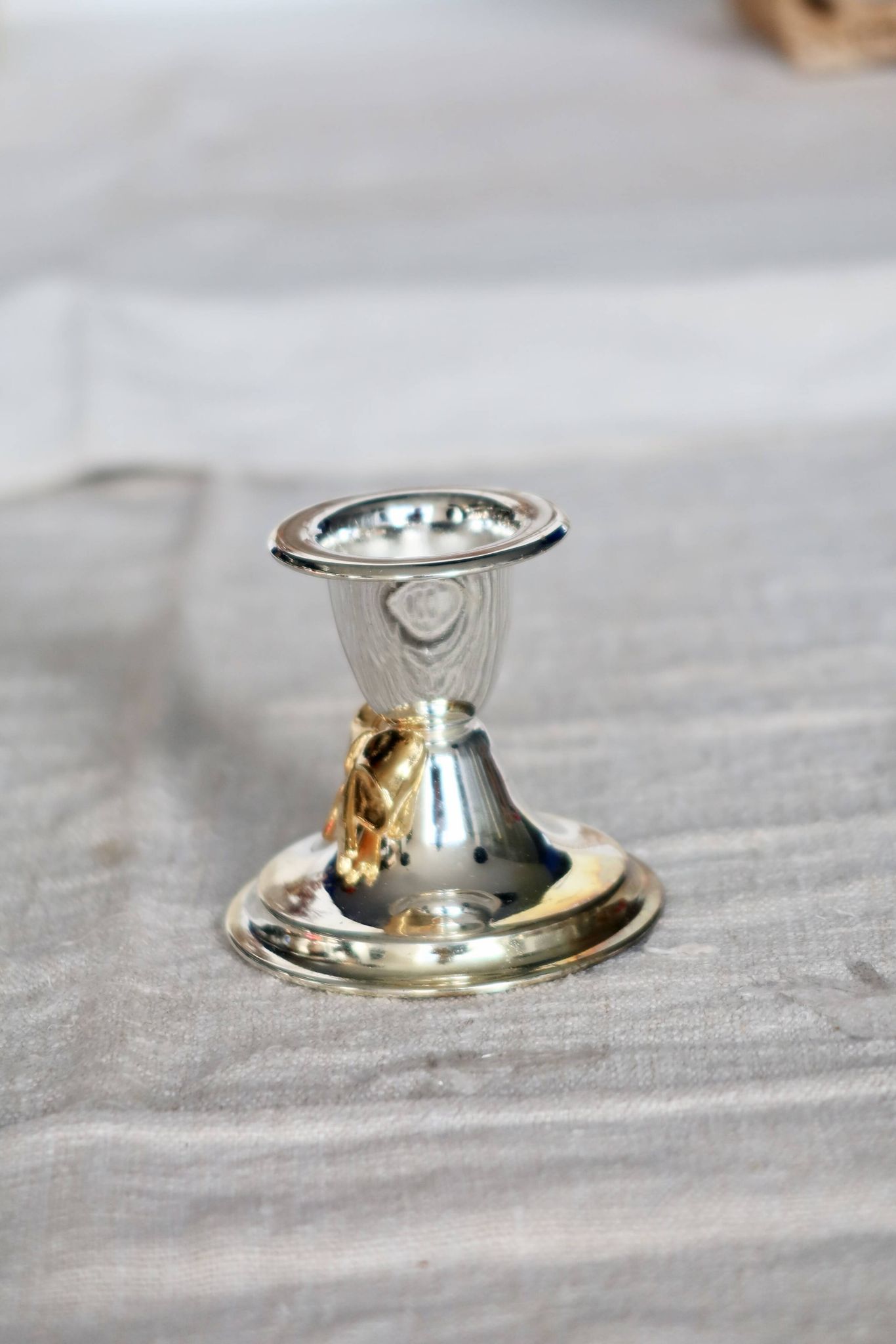 Small vintage silver-plated metal candlestick with a gold bow