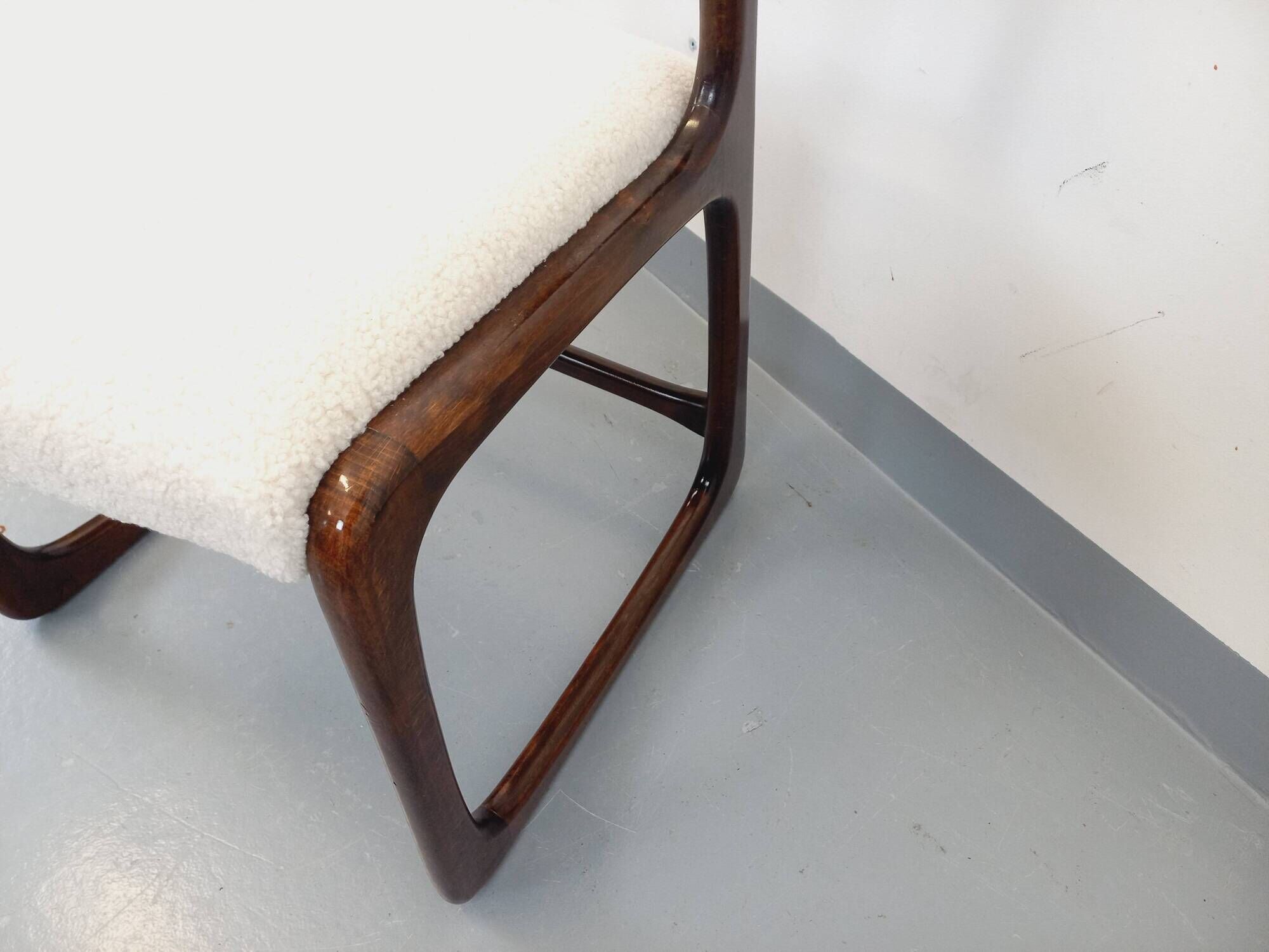 Vintage sled chair by Baumann in wood and boucle fabric.