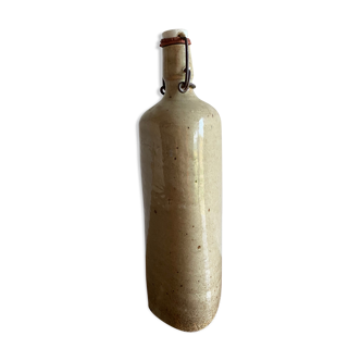 Old triangular bottle in glazed sandstone