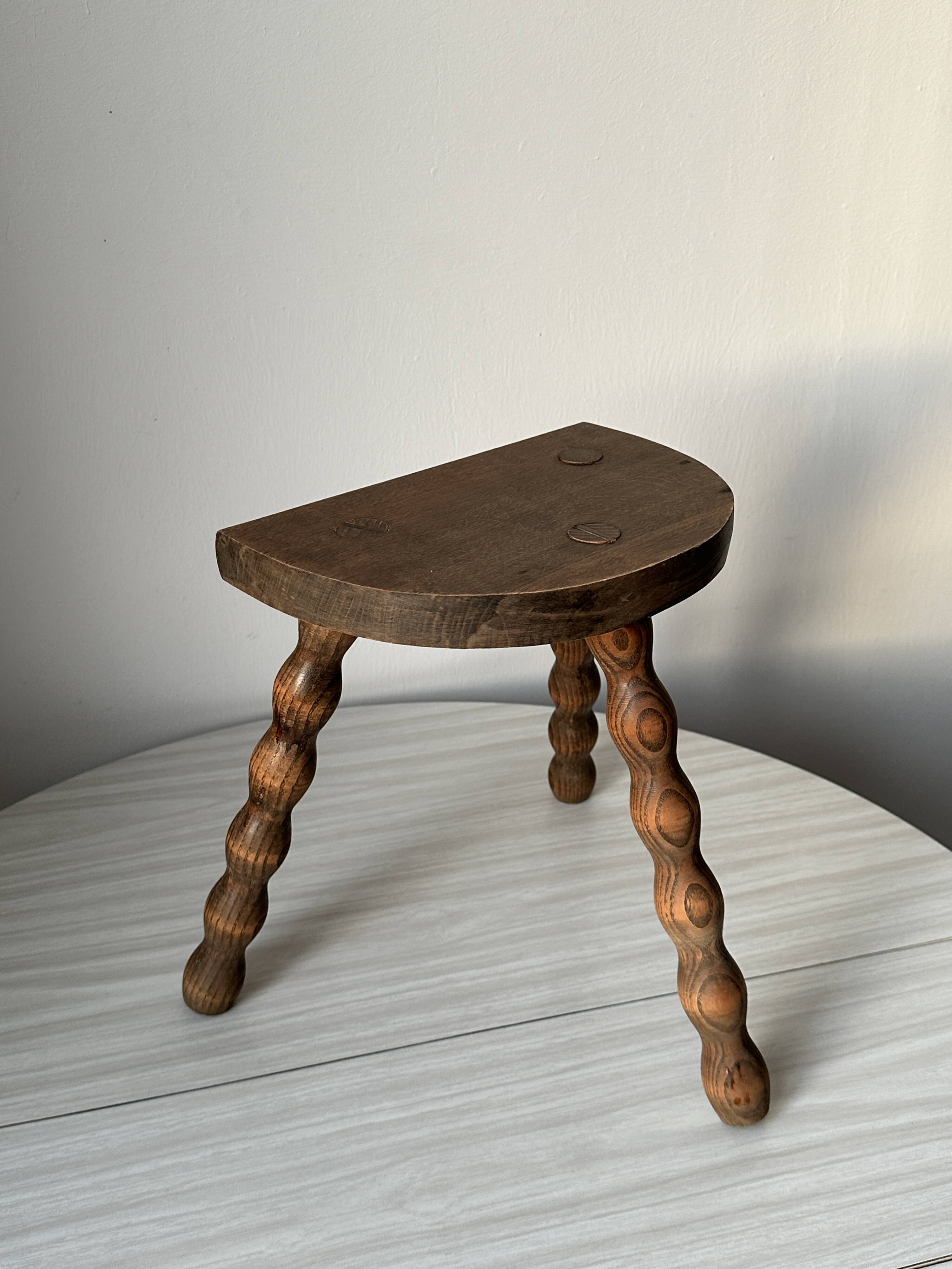 Wooden bench with three twisted legs