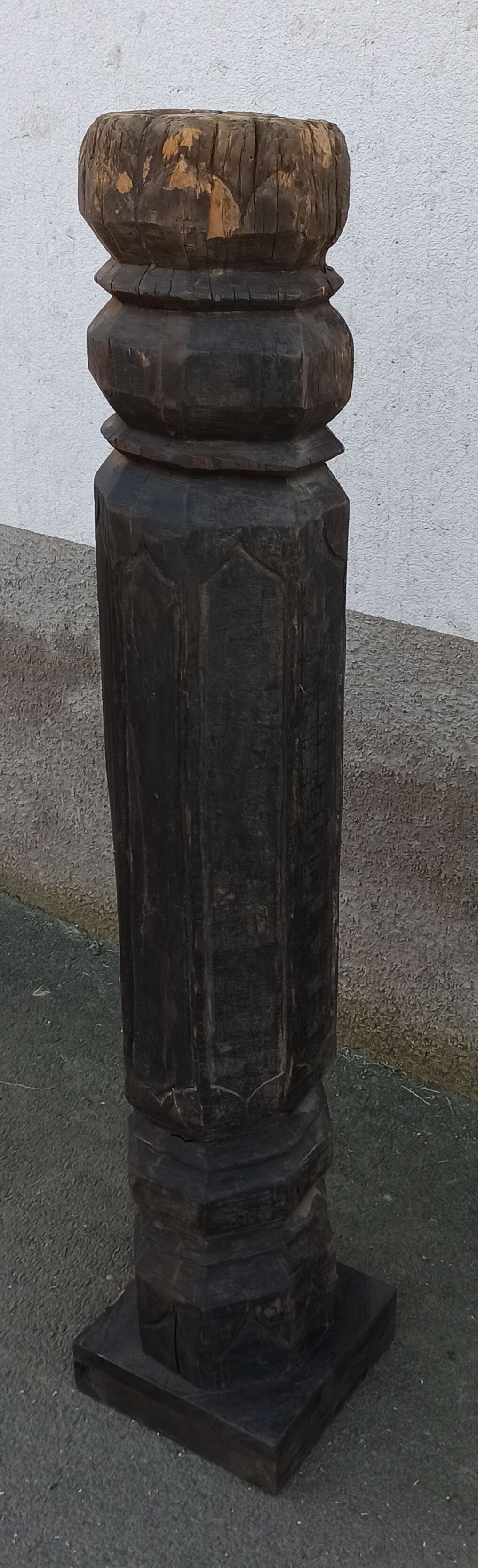 Old wooden pillar on pedestal