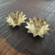 Pair of brass candle holders in the shape of a lotus flower.