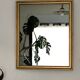 Antique mirror with a gilded frame and beaded border.