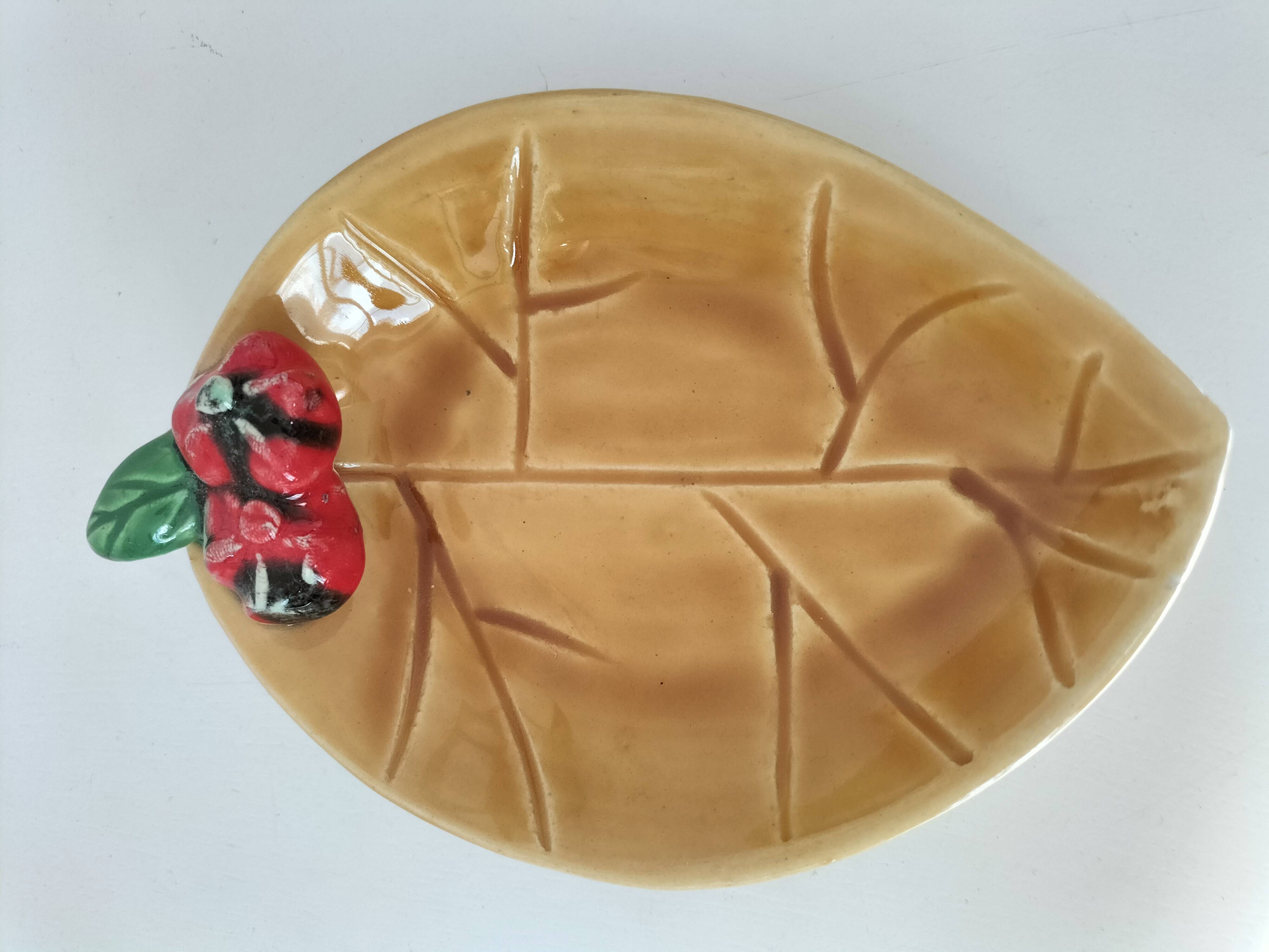 Two relief bowls with leaf designs, radishes, and tomatoes.