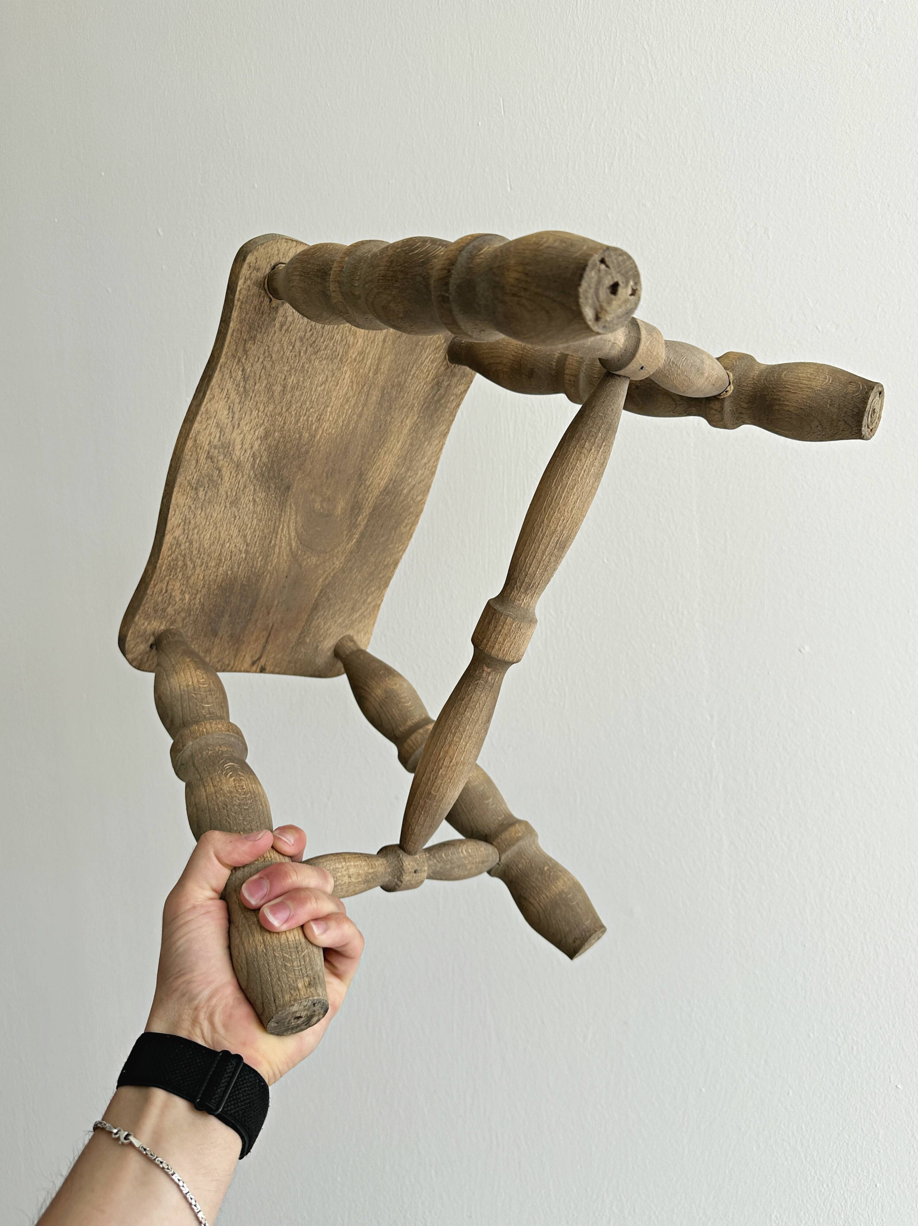 Antique wooden stool with four turned legs.