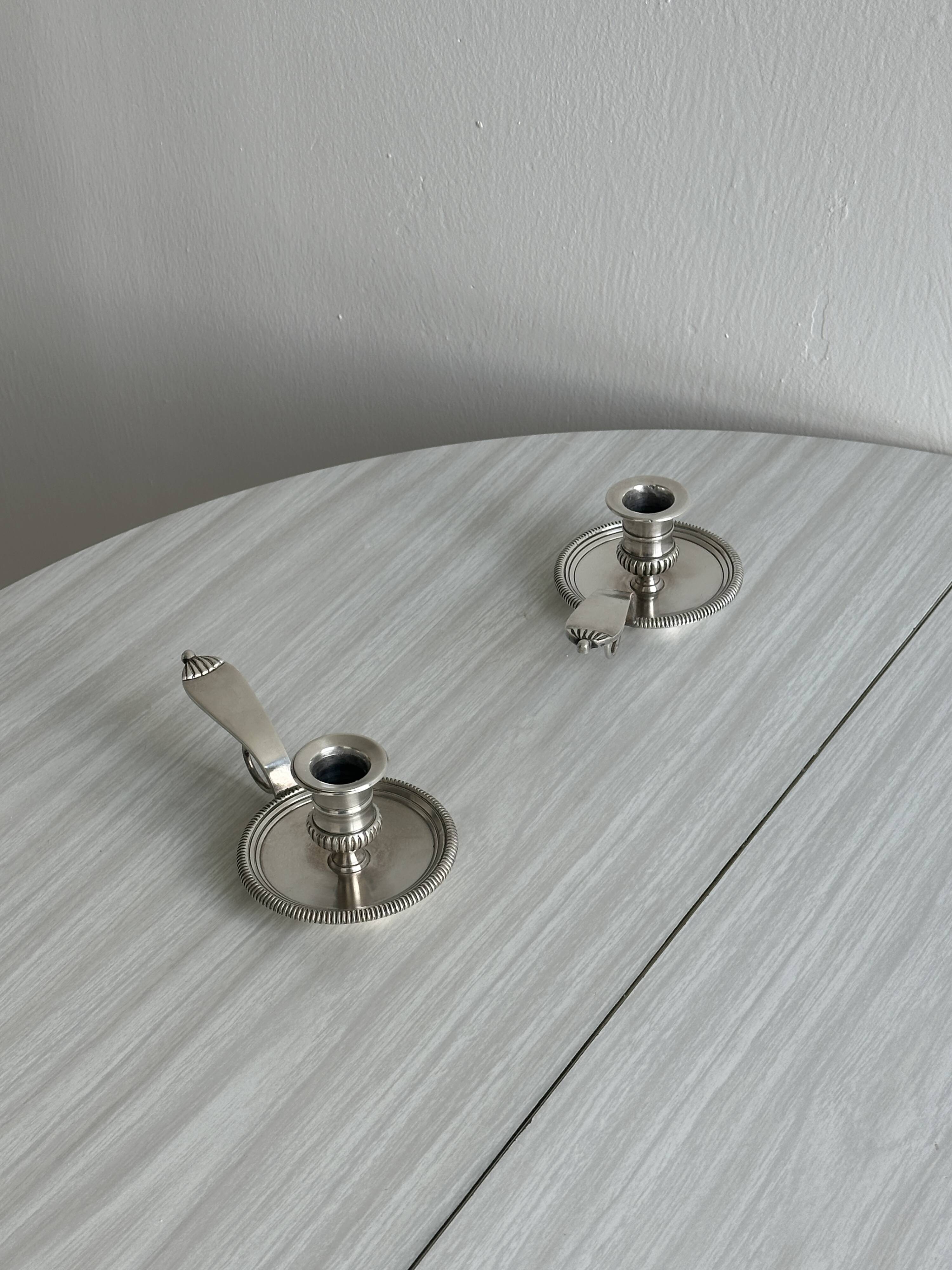 Pair of shiny silver metal candlesticks