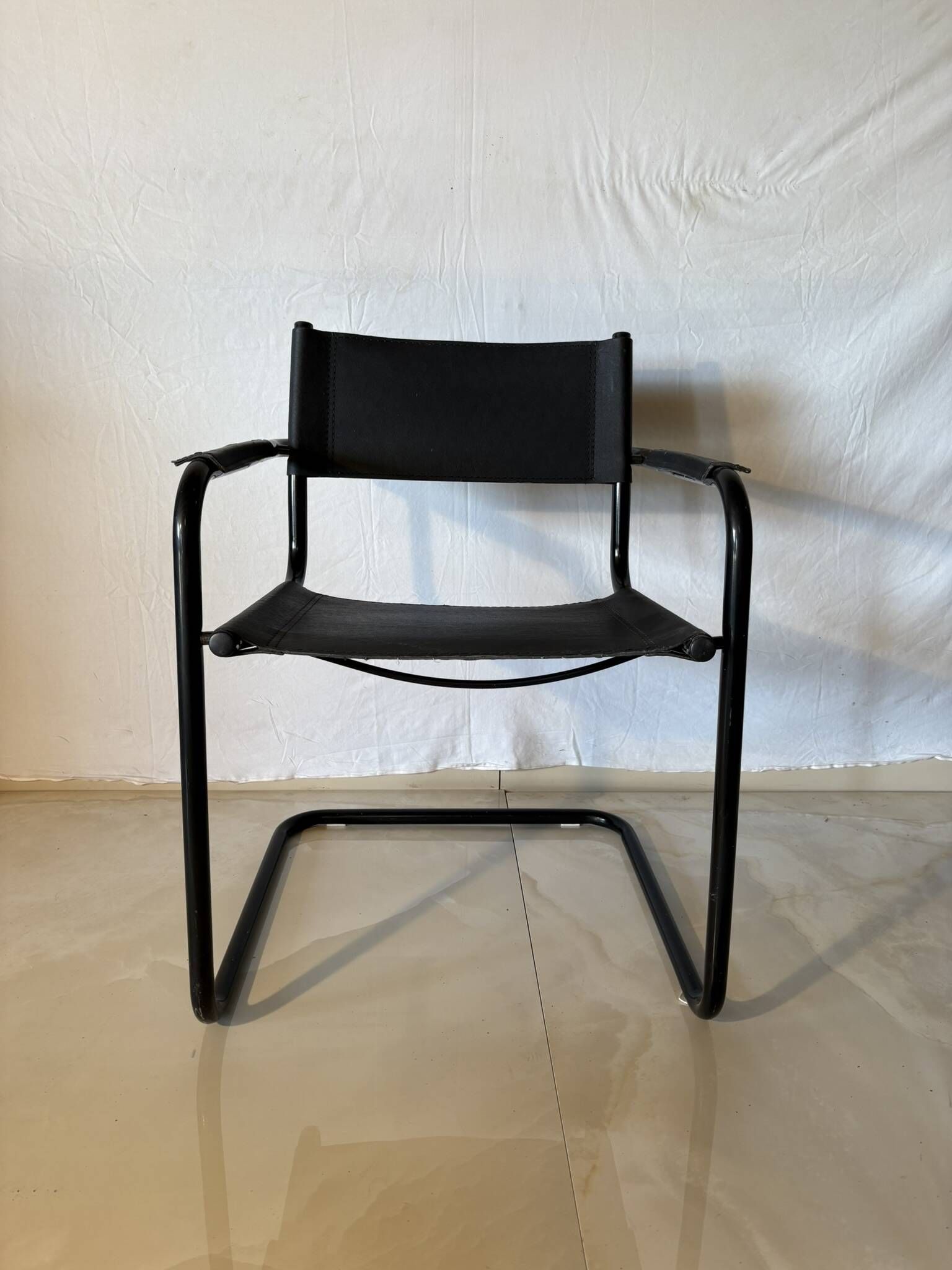 Set of 12 vintage black leather and tubular steel chairs – Italy, year
