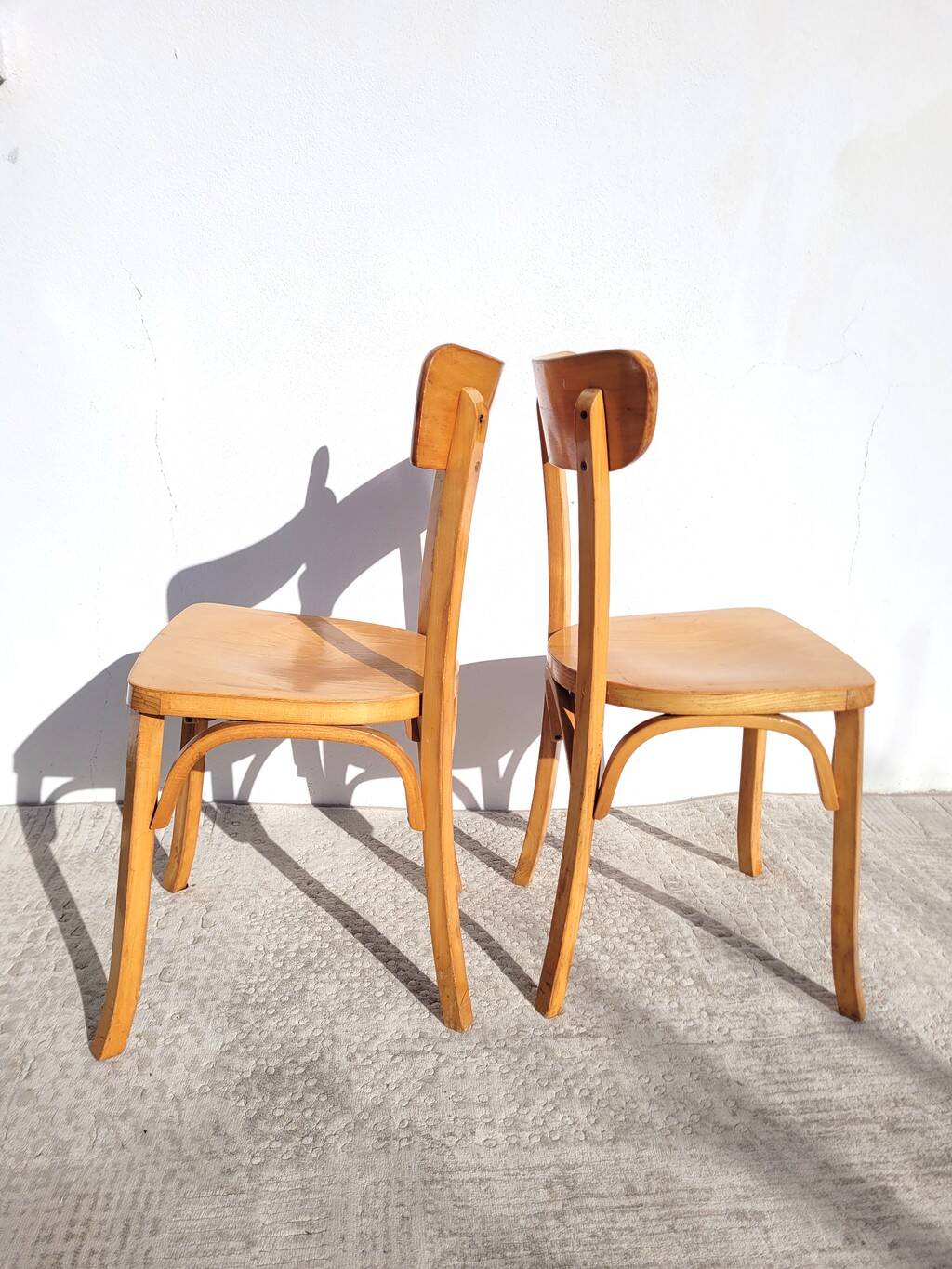 Pair of vintage bistro chairs in golden oak.