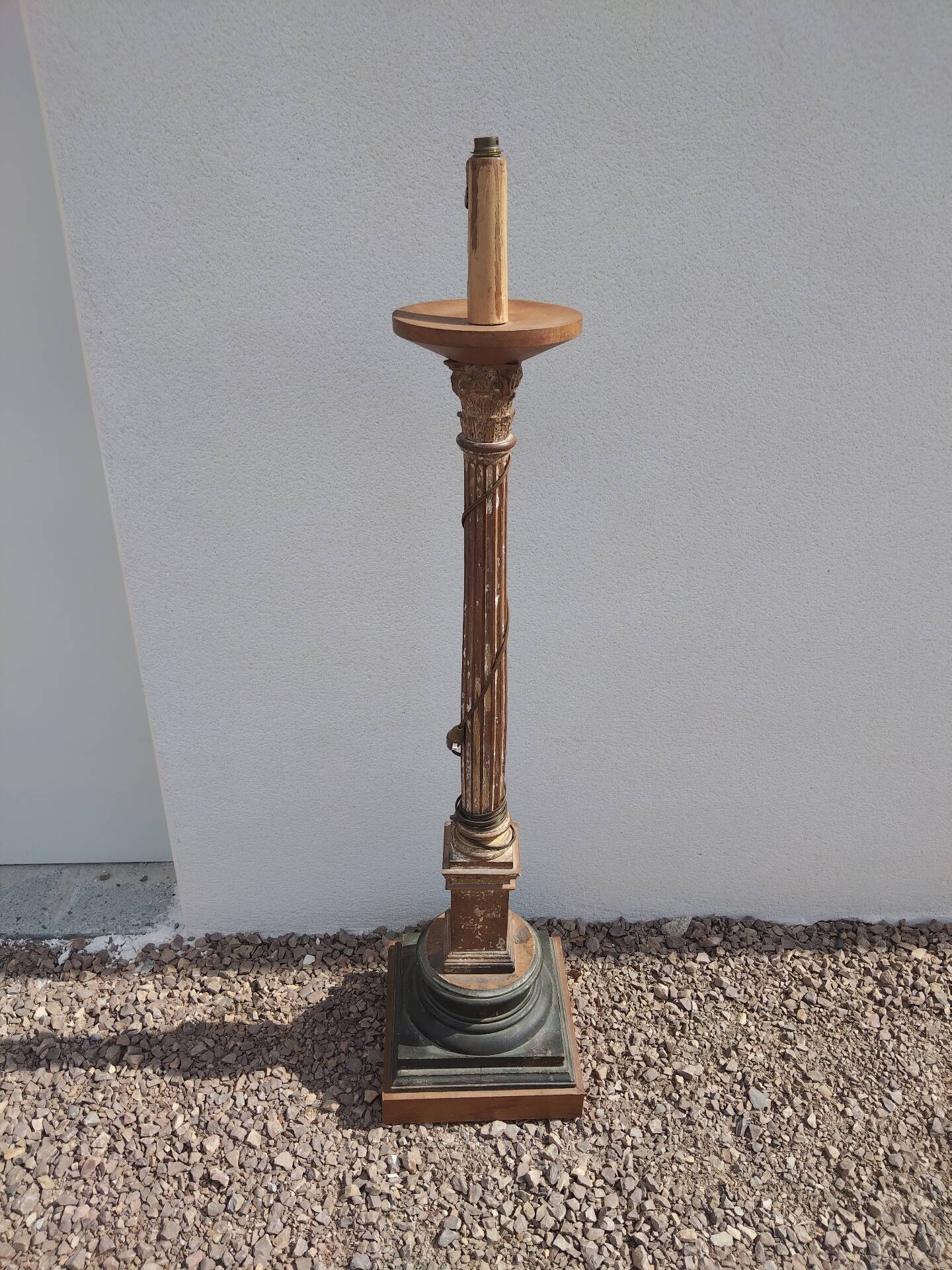 Large antique church candlestick in carved wood transformed into a lamp.