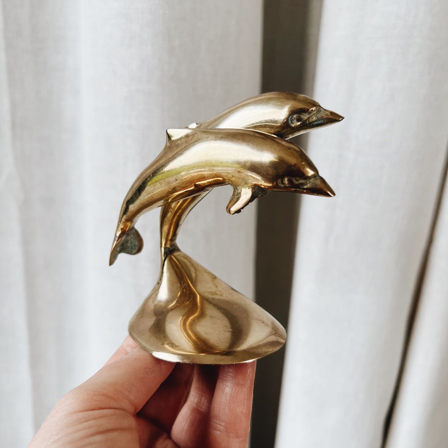 Duo of brass dolphins