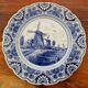 Delft Blue earthenware plate with a mill by a river decoration