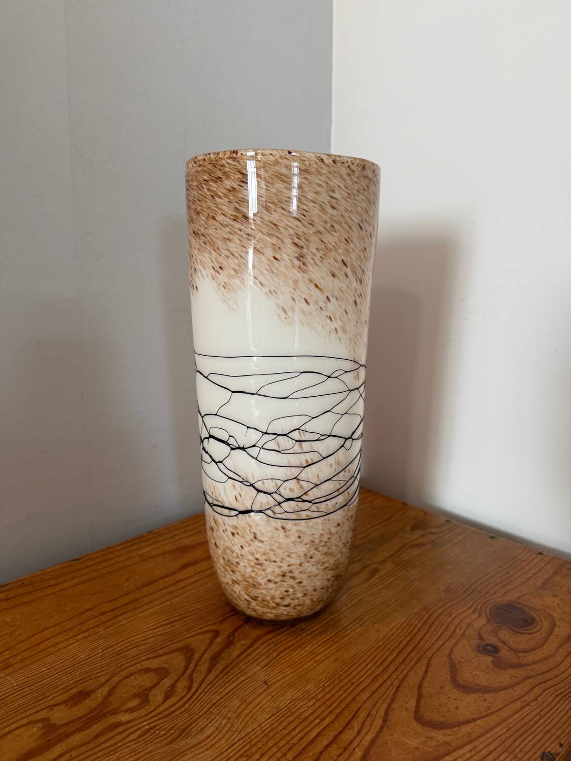 Large hand-blown glass vase in brown and beige.