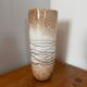 Large hand-blown glass vase in brown and beige.