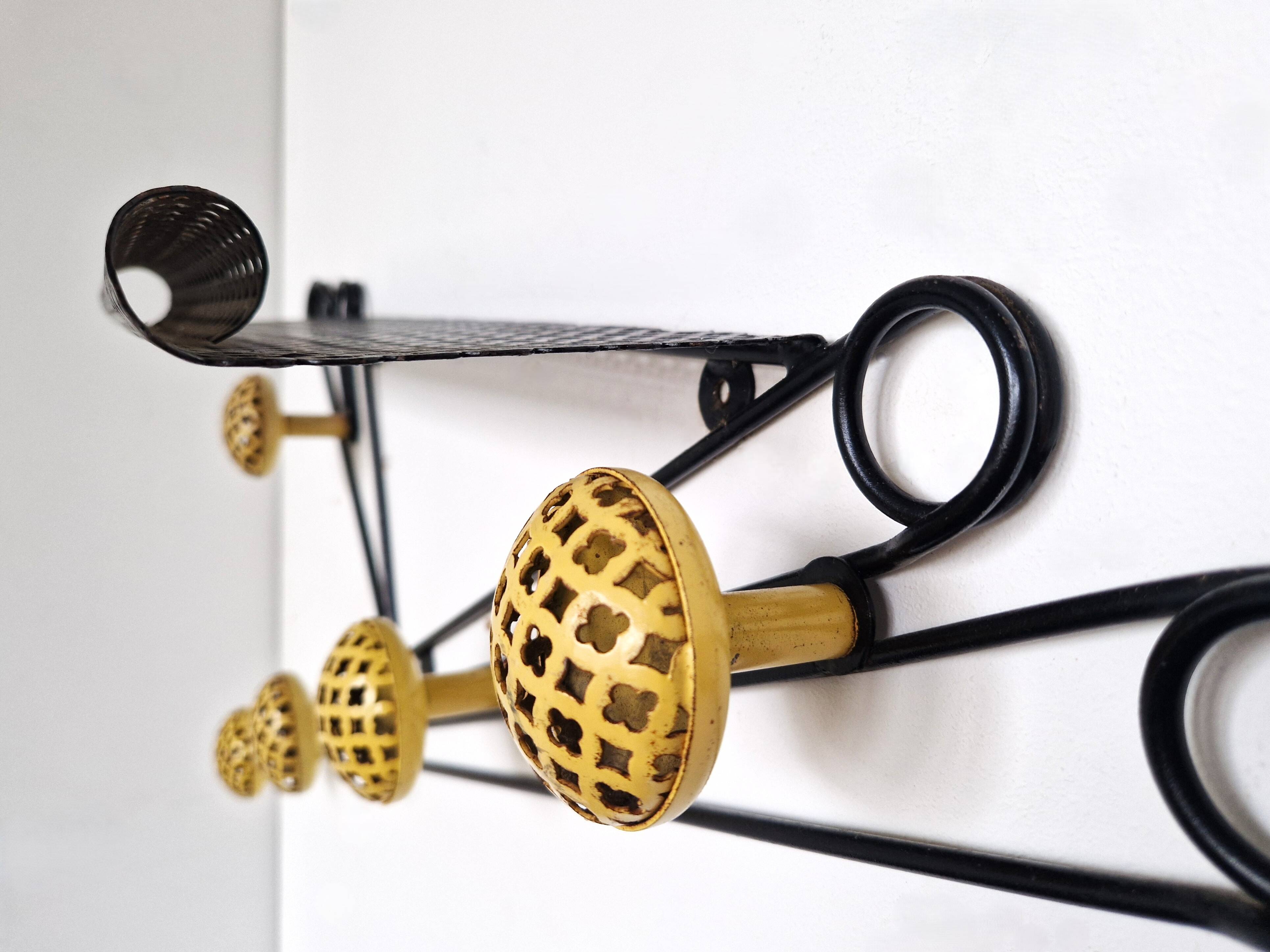Black and yellow wall coat rack, France