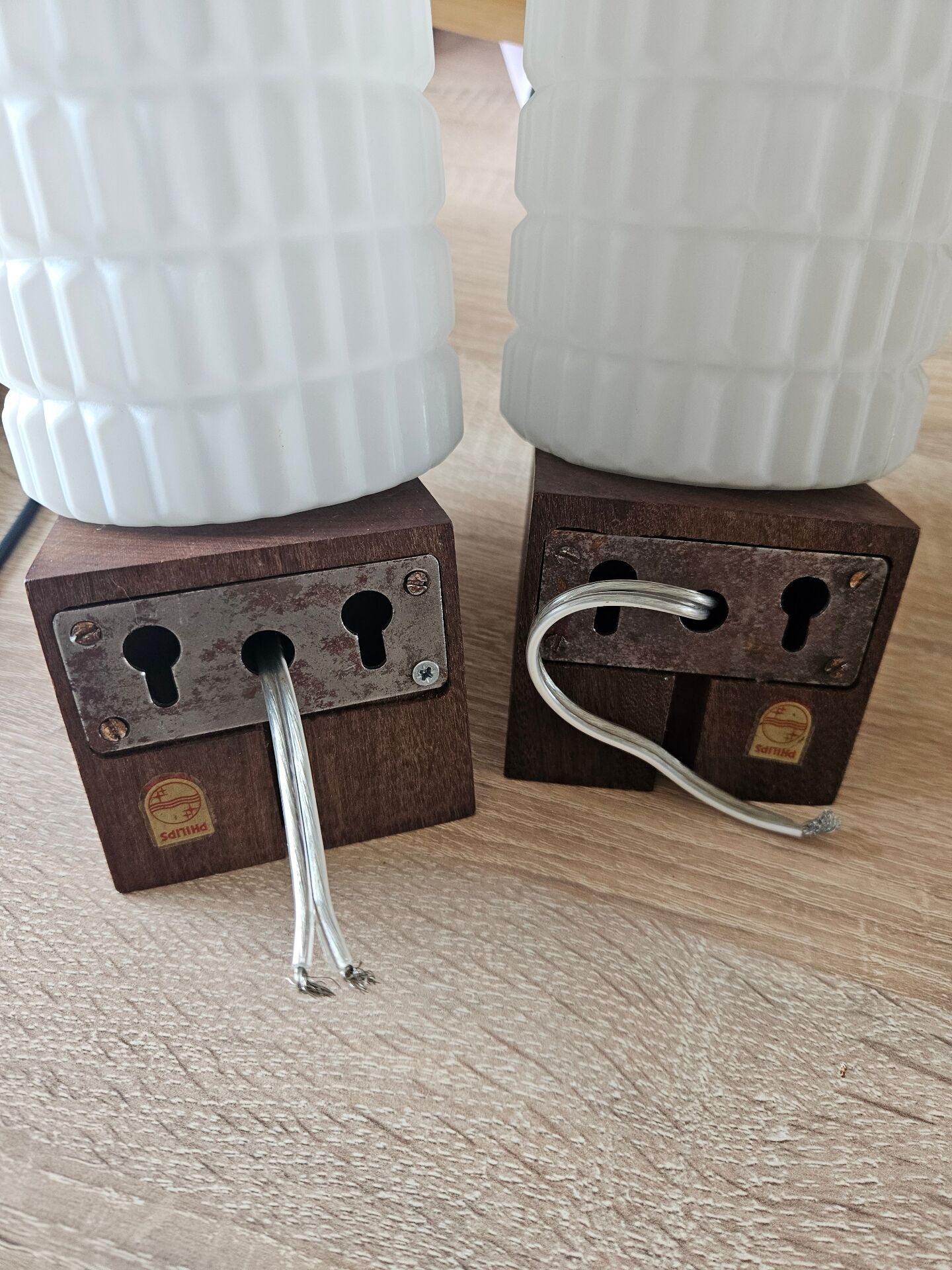 Philips wall sconces in wood and white opal.