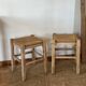 Pair of antique stools in raw solid wood with straw seats.