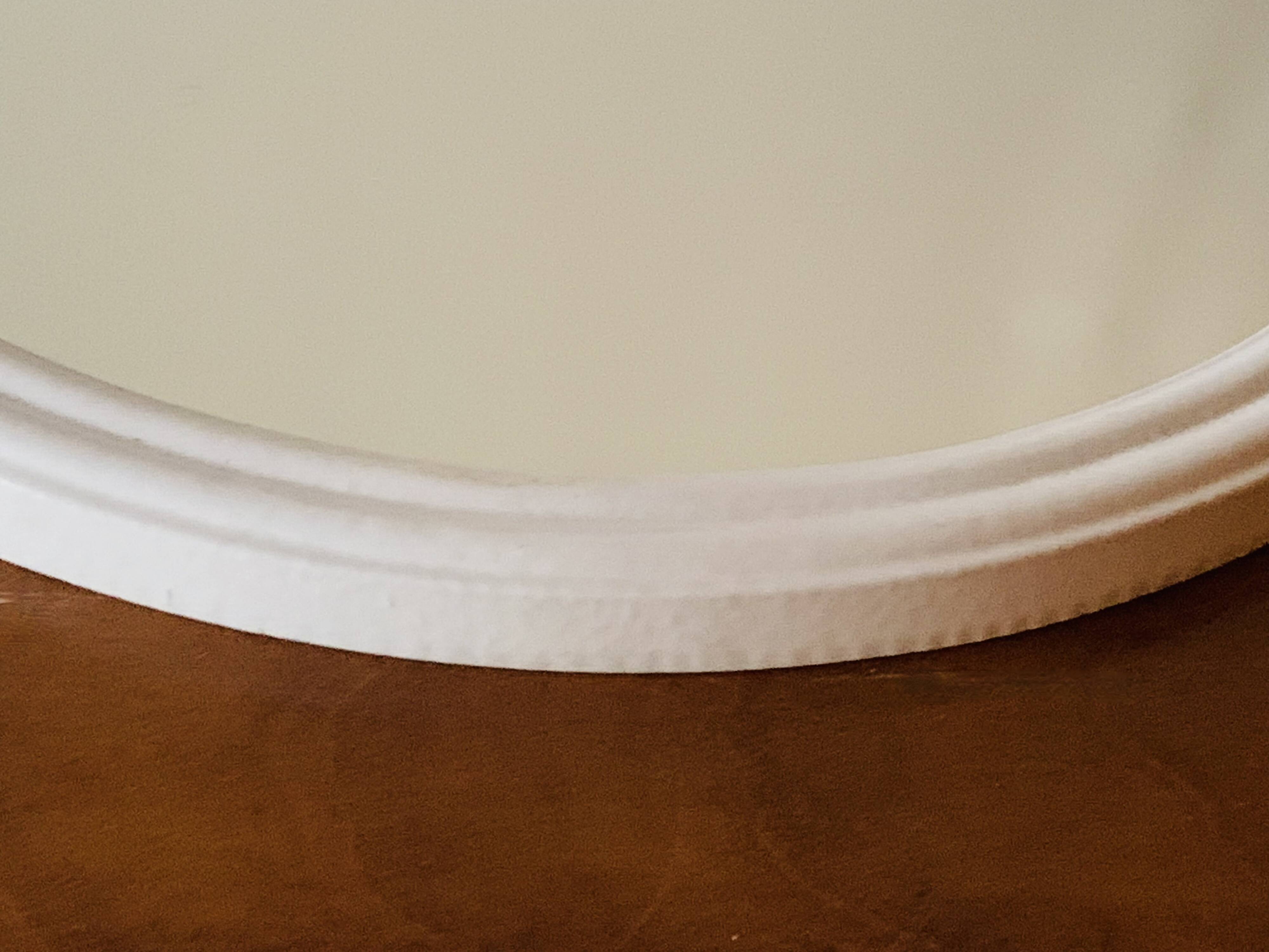 Oval mirror in vintage enameled white cast iron