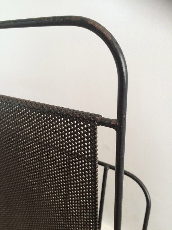 Black lacquered metal and perforated metal magazine rack designed by Mathieu Matégot 50.