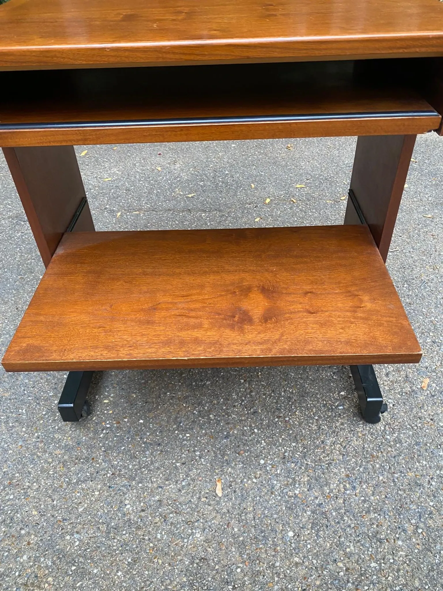 Small Scandinavian-style computer desk on wheels made of wood.