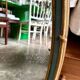Oval mirror in wood and green and gold stucco, 75 x 42 cm