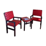 Black and red leather armchairs with its coffee table