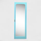 Beveled mirror on turquoise Parisian door