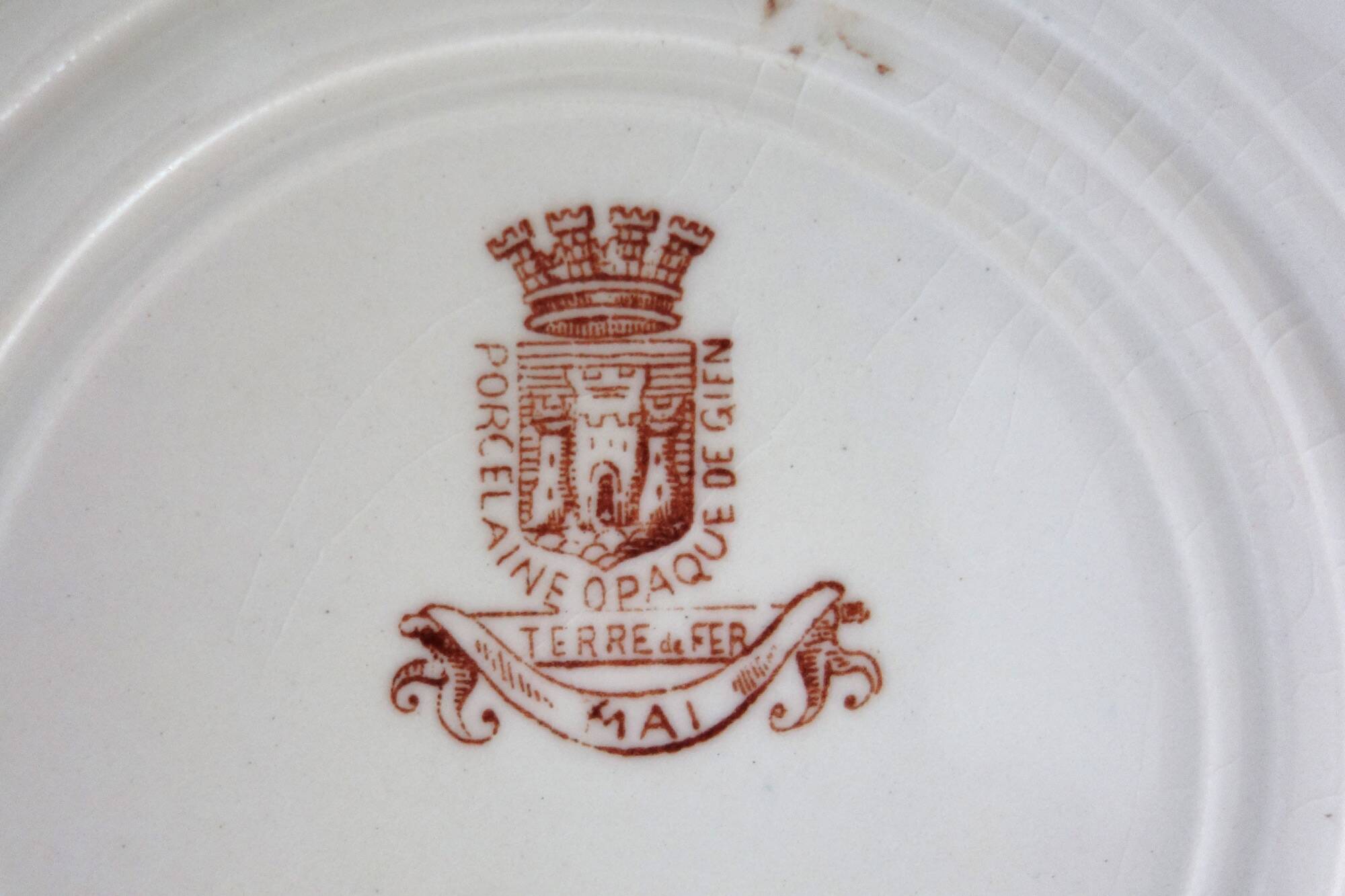 11 deep plates Terre De Fer Gien model Mai circa 1900